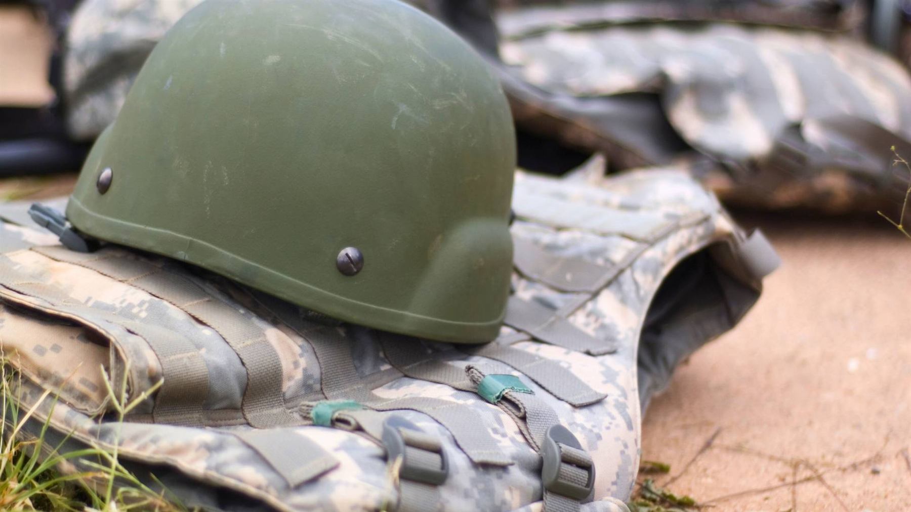 Combat helmet resting on a ballistic protection vest