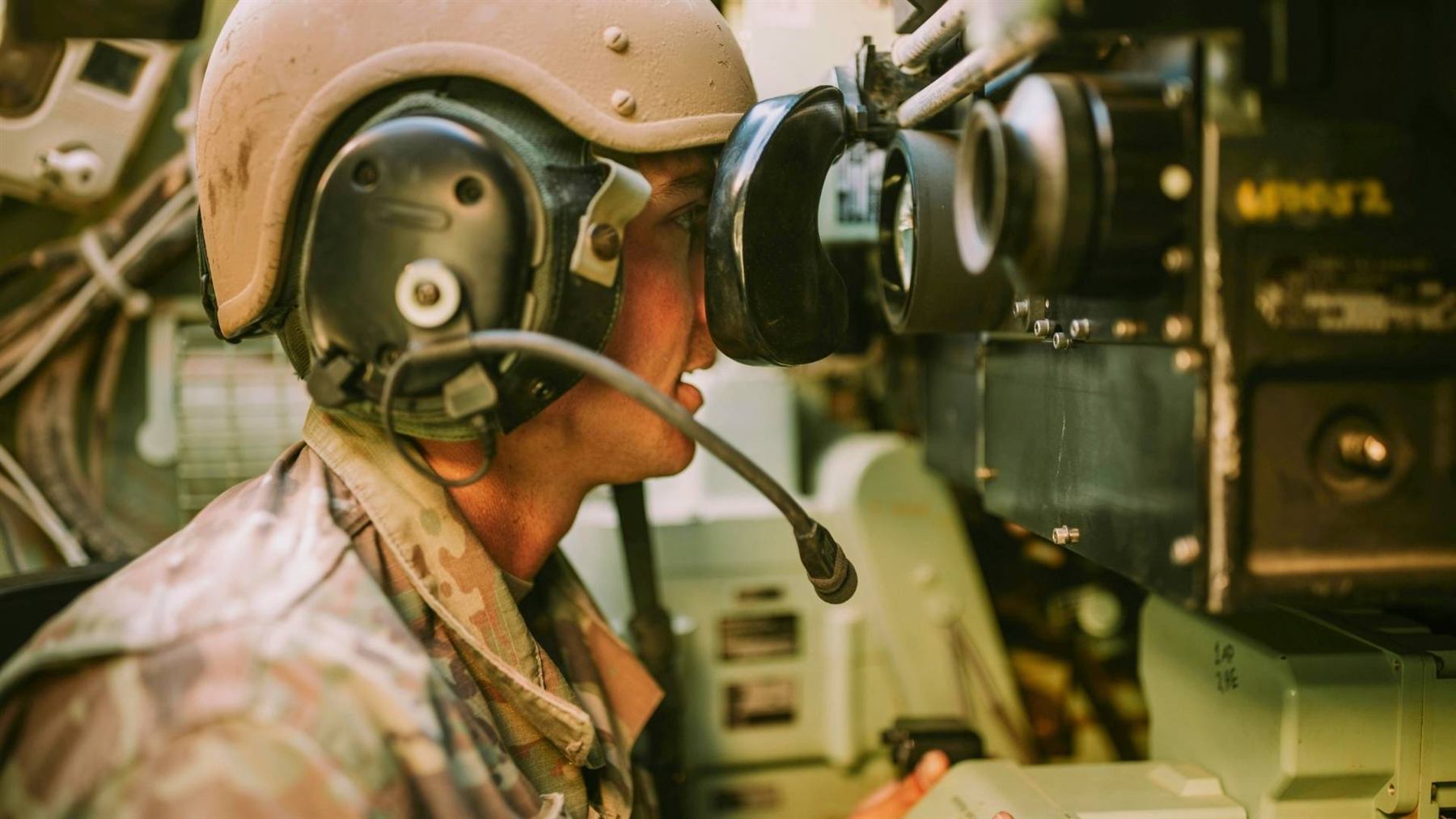 Vehicle crew operating optics inside an armoured platform